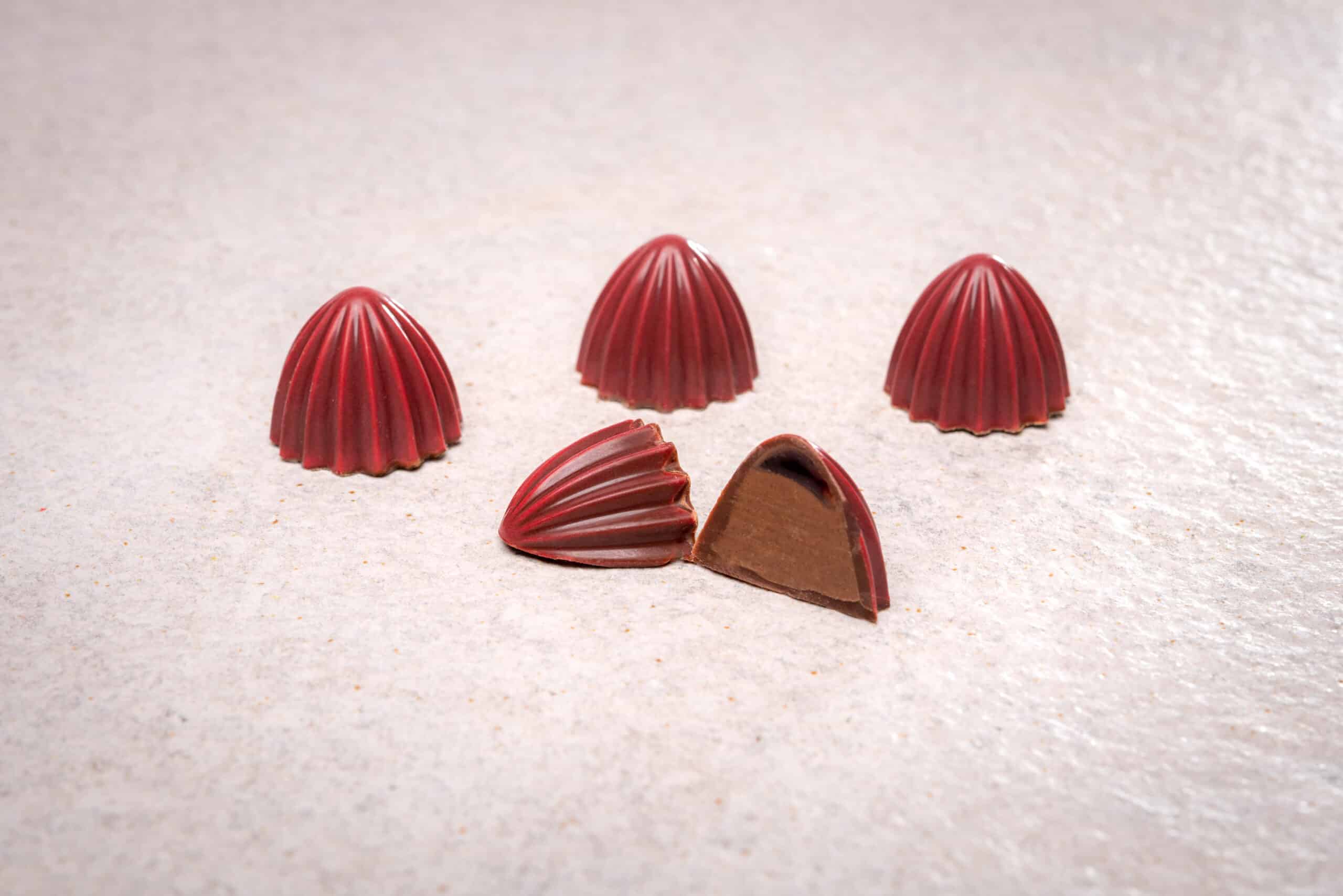 Pralines Bonbons fünf angeschnitten rot weisser Hintergrund spitze Produktfotografie Schweiz Zürich BeLighted